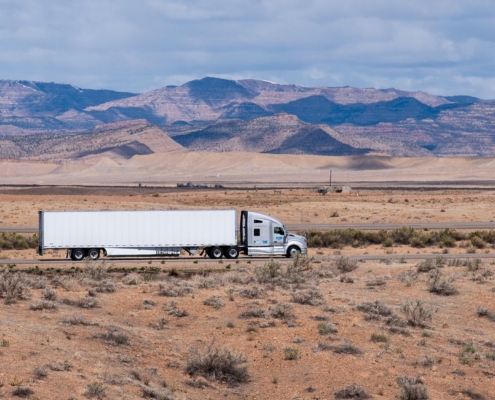 panoramic view of a dry van trailer driving through the desert